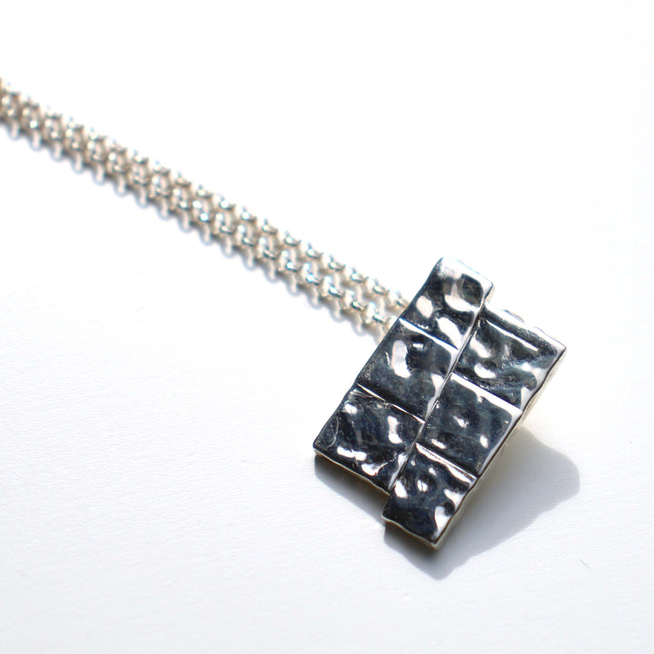 Dip slip fault pendant in sterling silver by ontogenie science jewelry