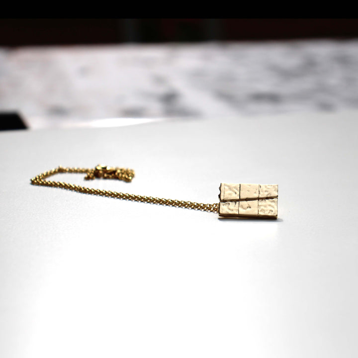 strike slip pendant in 14K gold plated brass by ontogenie science jewelry