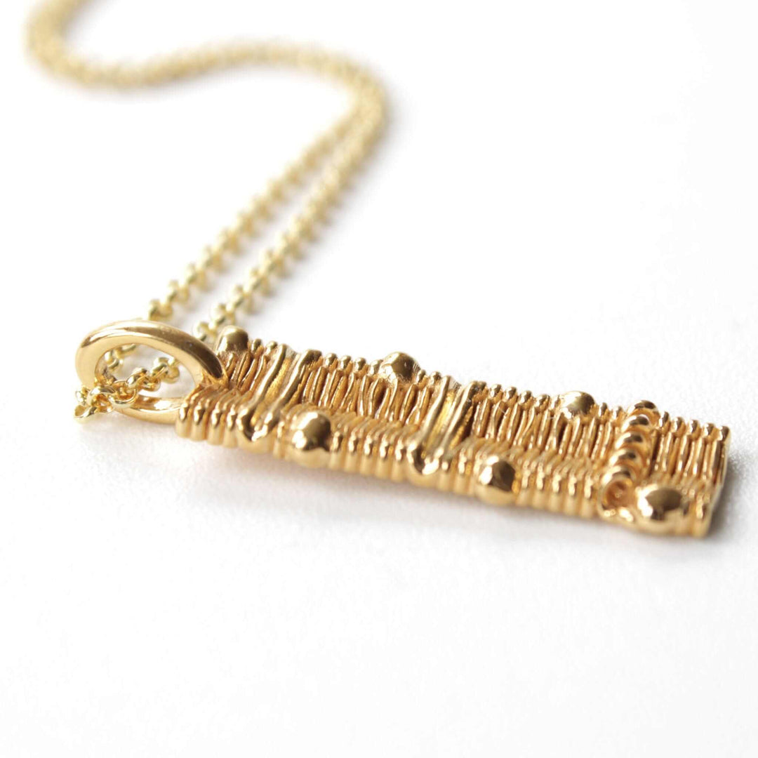 cell membrane pendant in 14K gold plated brass Ontogenie Science Jewelry