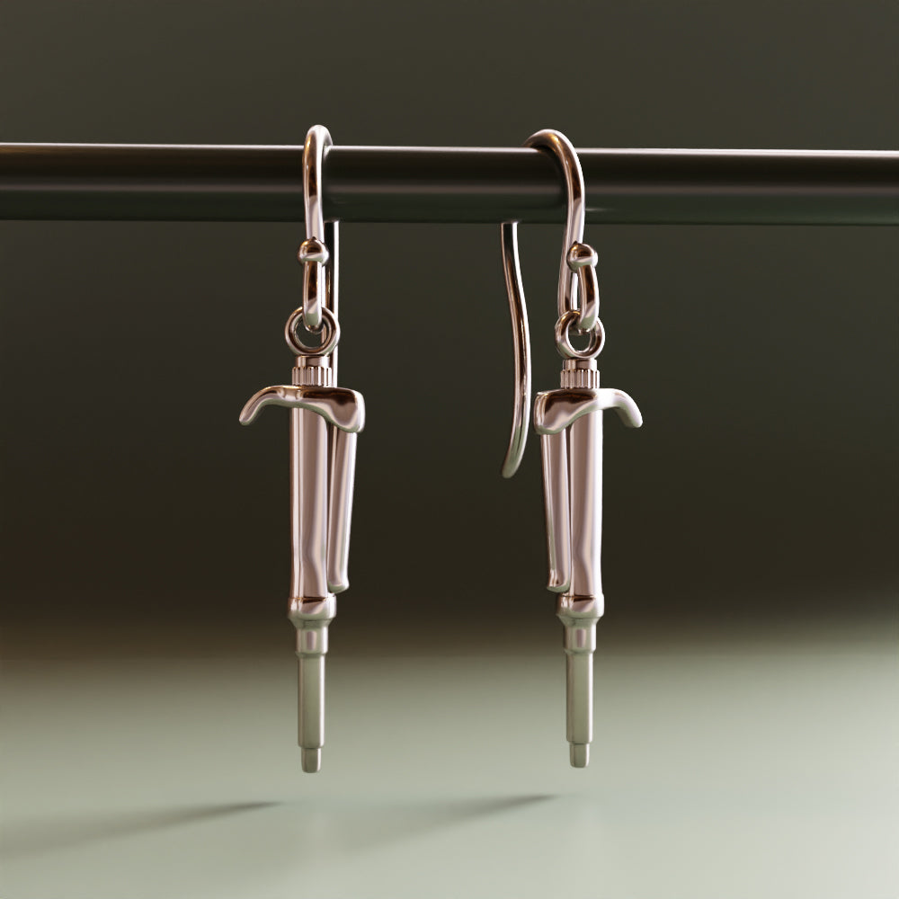 computer render of silver pipette earrings by Ontogenie Science Jewelry