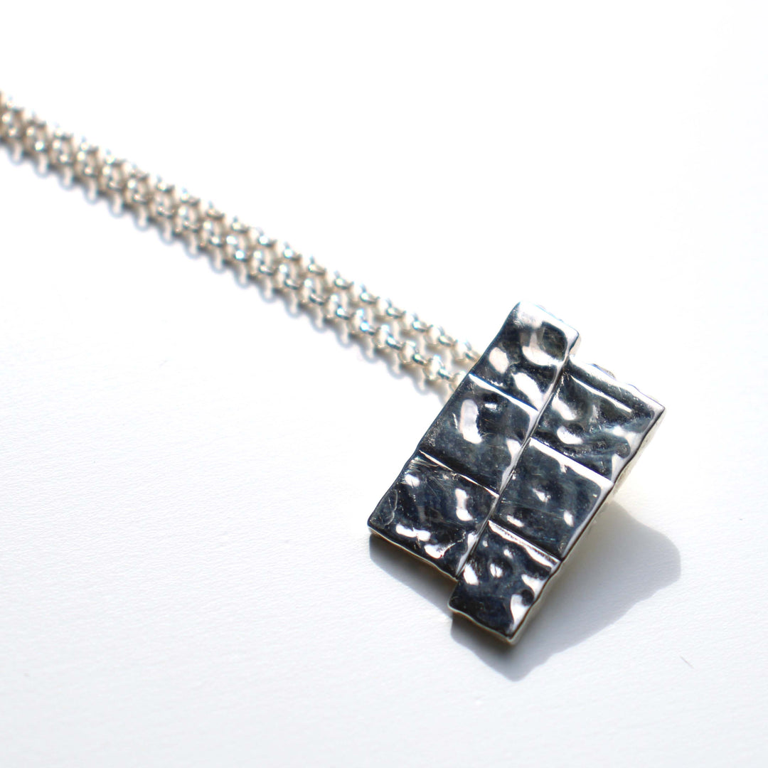 Dip slip fault pendant in sterling silver by ontogenie science jewelry