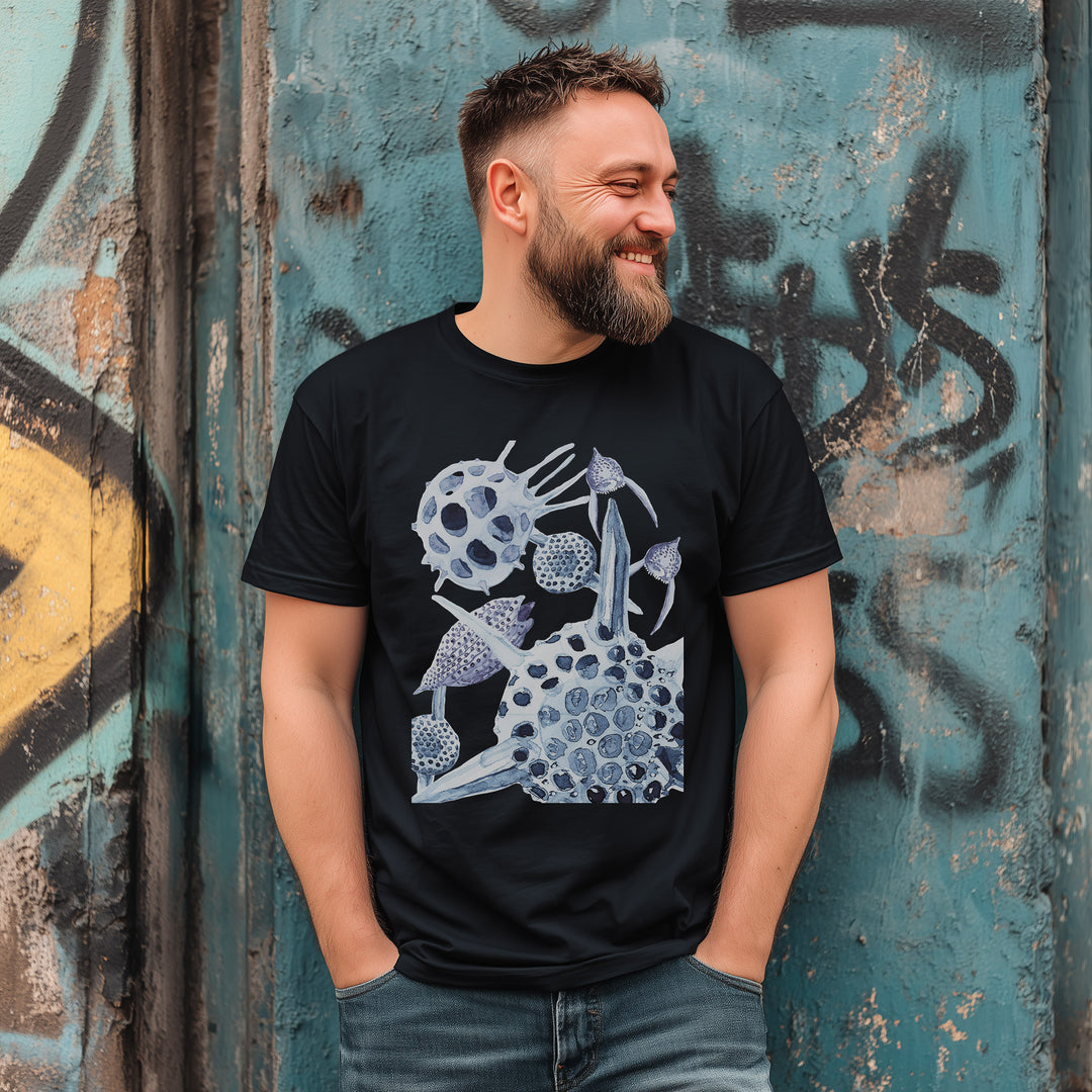 radiolaria tshirt in black, worn by a bearded man leaning against a graffit wall