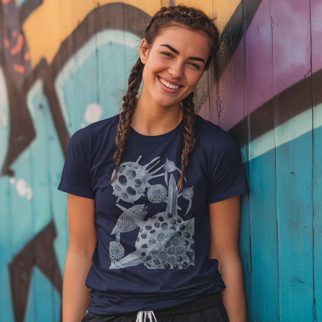 radiolaria tshirt in navy blue, worn by female model with braids against a graffiti wall