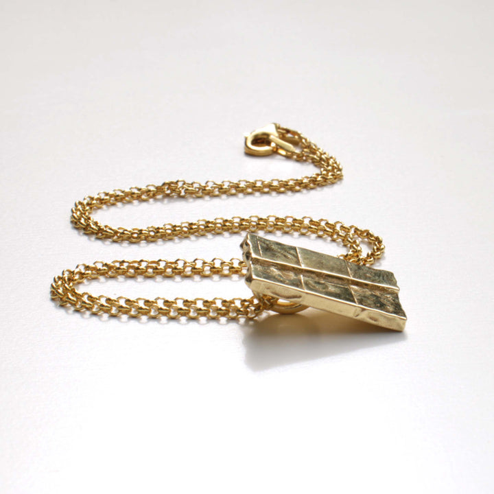 strike slip pendant in 14K gold plated brass by ontogenie science jewelry