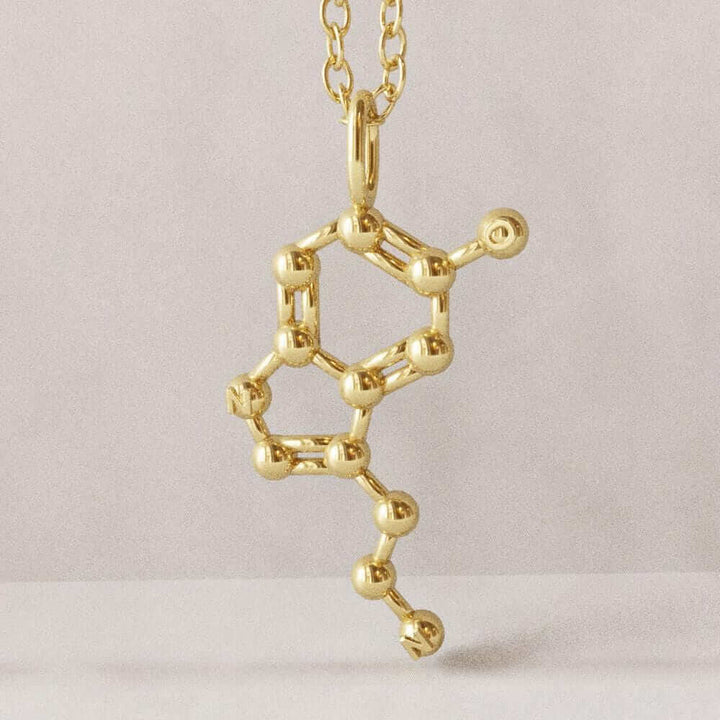 Serotonin molecule pendant gold plated brass computer render ontogenie science jewelry