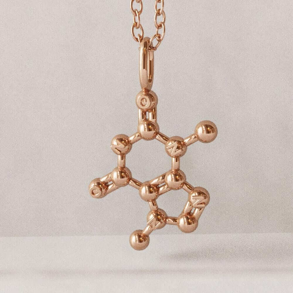 theobromine molecule pendant in rose gold plated brass computer render ontogenie science jewelry