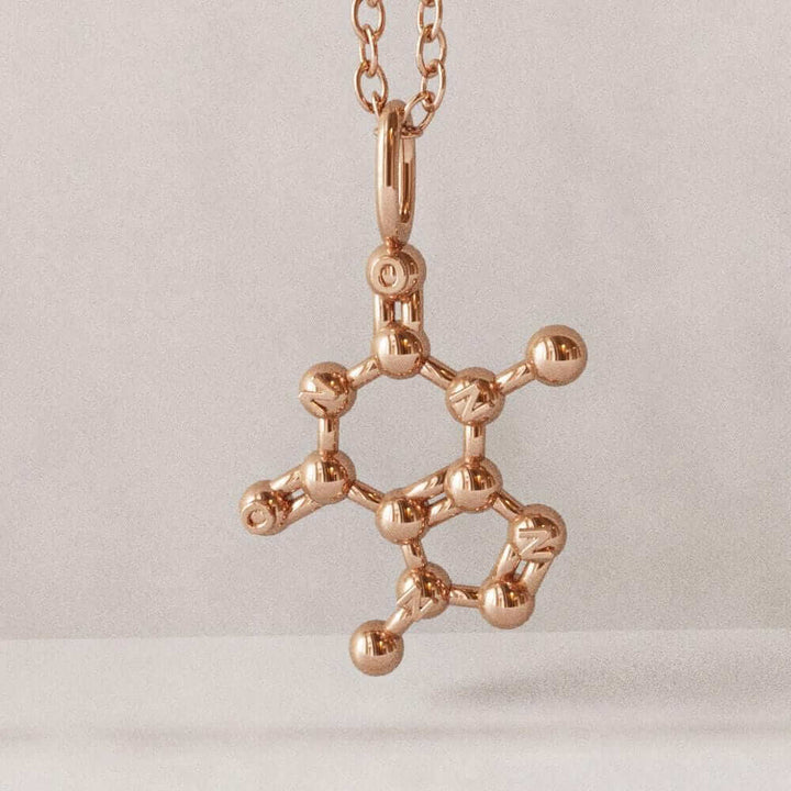theobromine molecule pendant in rose gold plated brass computer render ontogenie science jewelry