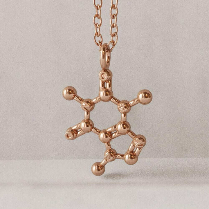 rose gold render of caffeine pendant ontogenie science jewelry