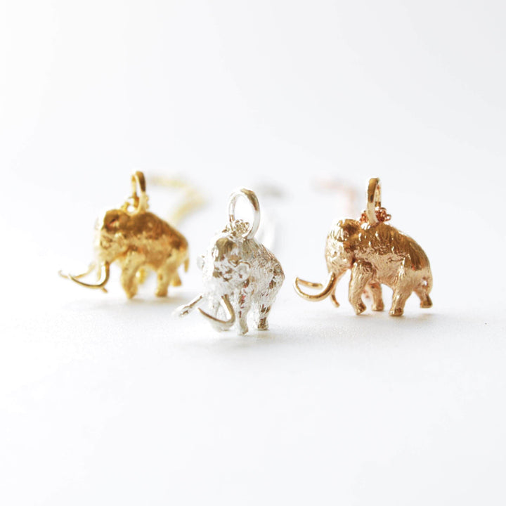 Woolly mammoth pendants in 14K gold plated brass, silver and bronze Ontogenie Science Jewelry