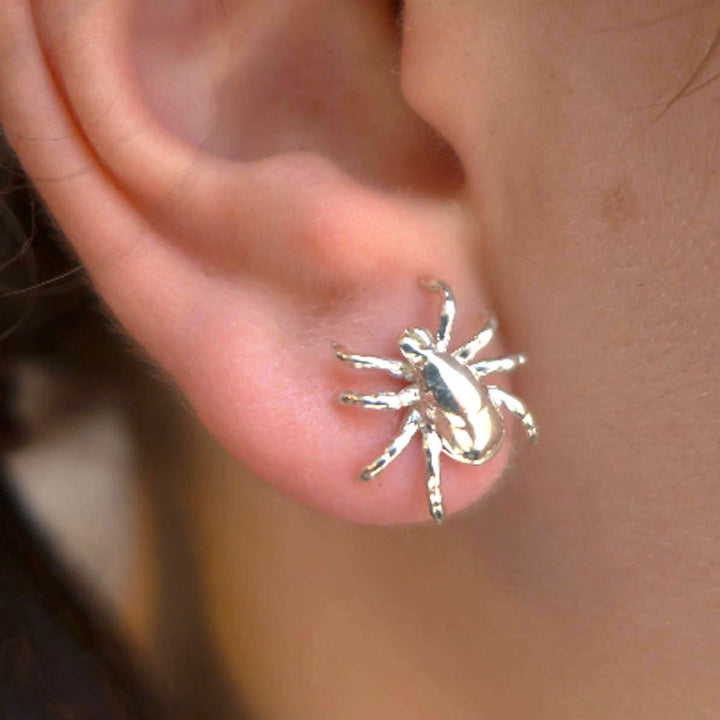 sterling silver tick earring on model ontogenie science jewelry